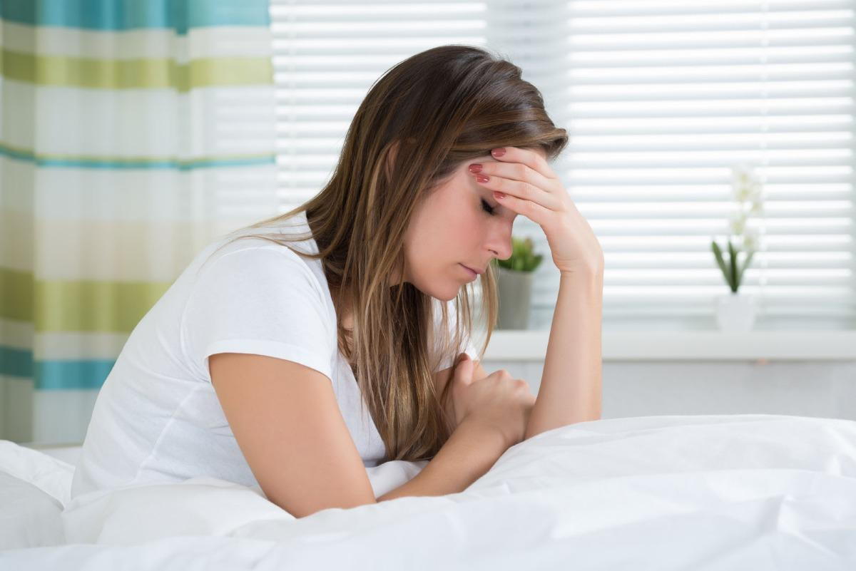 Woman waking up with a headache