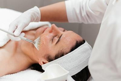 Woman receiving chemical peel for hyperpigmentation
