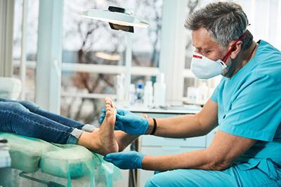 Doctor checking the foot condition of patient