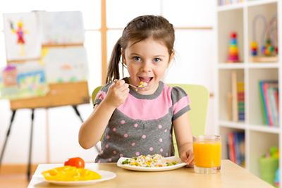 Young-Girl-Enjoying-a-Nutritious-Meal-with-Orange-Juice