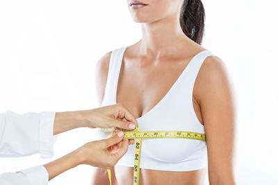 Woman-in-white-bra-measuring-the-breast-size-by-doctor.