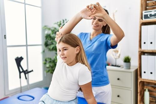 Chiropractor providing gentle chiropractic treatment to a child patient
