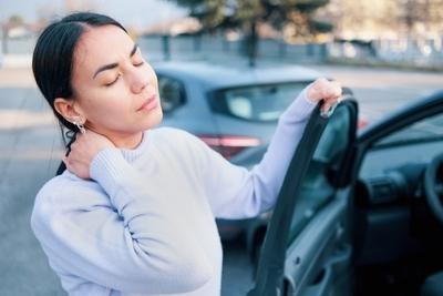 Woman suffering from whiplash after car accident.