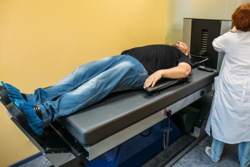 Male patient receiving spinal decompression therapy for back pain relief