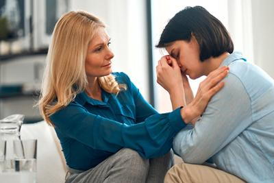 Counselor providing emotional support to client experiencing stress