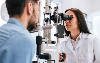 Doctor-checking-the-man's-patient-eyes-for-consultation-on-clinic.