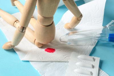 Concept image of rectal bleeding in a toy model and medical tools
