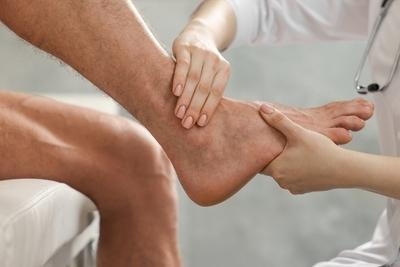 Therapist massage the foot of patient.