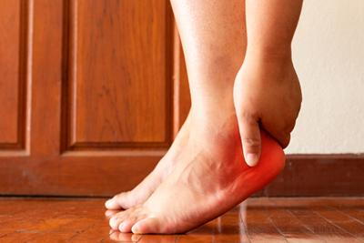 Person with heel pain in red
