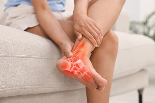 Woman suffering from foot arthritis pain