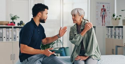A female client consulting a chiropractor for treatment after an auto injury.