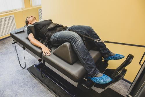 A man receiving spinal decompression therapy to relieve pain from a bulging disc.