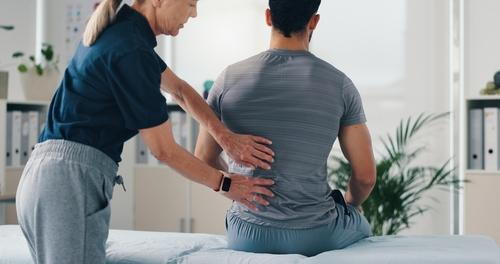 A man consulting a chiropractor to relieve back pain and improve mobility.