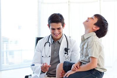 Doctor and a young boy on clinic for physical exam