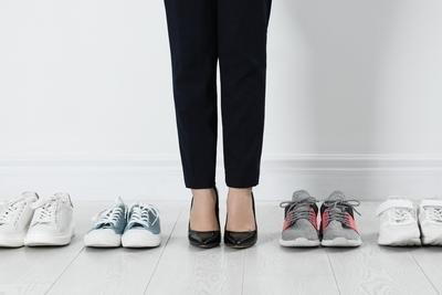 Person standing between different shoes to select proper footwear
