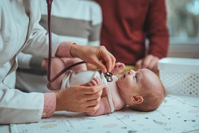 Newborn baby being examined by a pediatrician for early developmental progress.