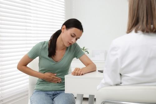 A woman consulting a gastroenterologist about IBS or IBD symptoms.