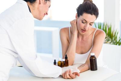 Doctor performing an allergy test to a woman