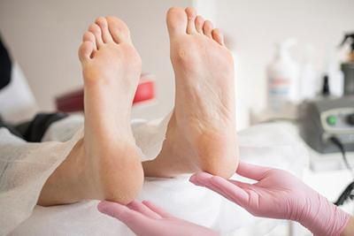 Patient with heel pain being examined by podiatrist