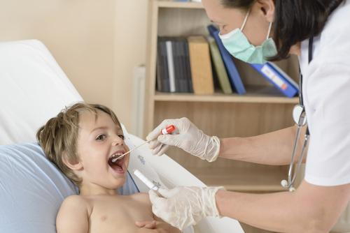 A child having a throat swab taken to test for strep throat.