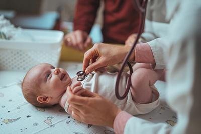 Doctor checking up the baby on clinic