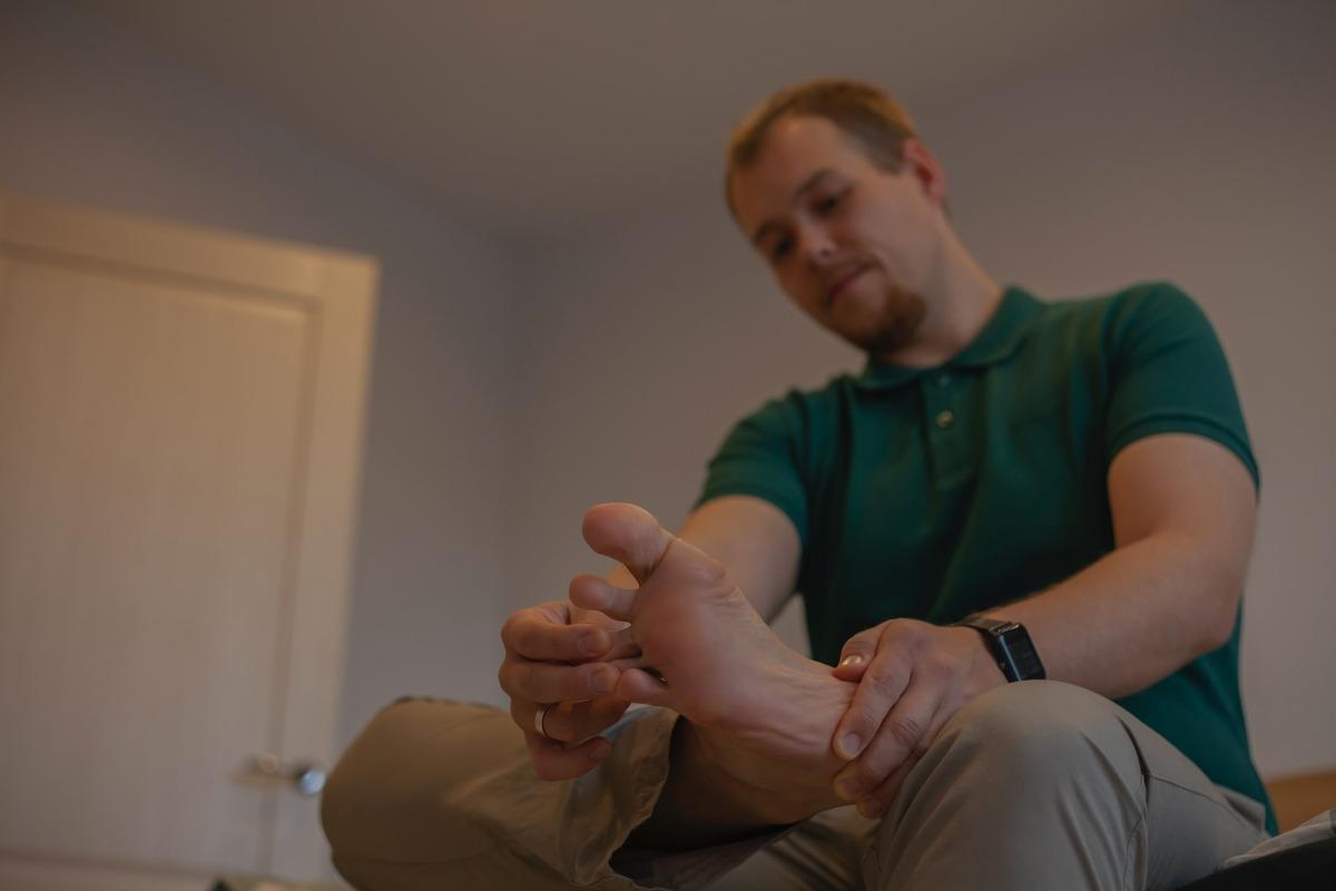 man holding his foot