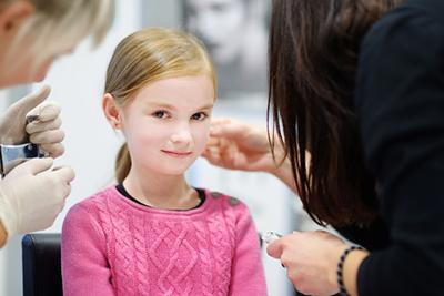 Smiling-Child-During-Her-Ear-Piercing