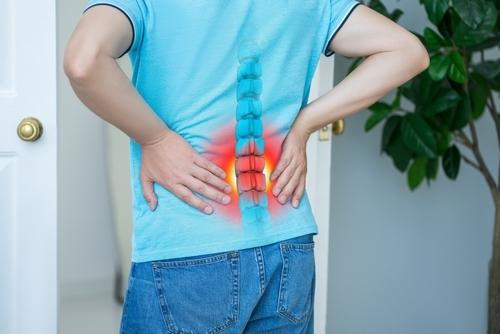 Man experiencing back pain related to a spinal disc injury