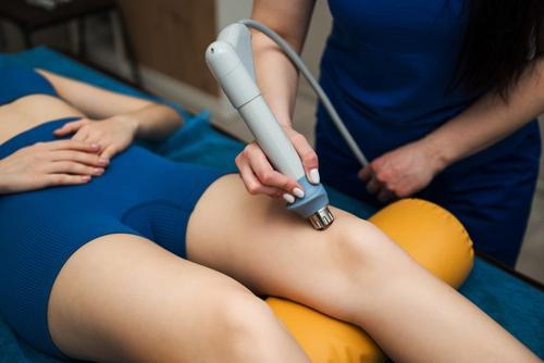 Patient receiving shockwave therapy to relieve hip pain and improve mobility