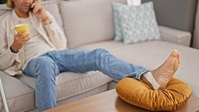 Man sitting and resting his injured foot