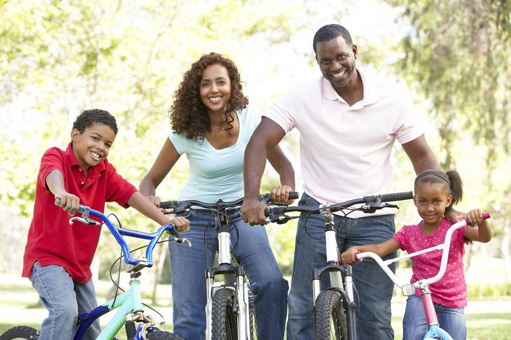 family of four riding bikes
