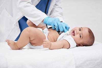 Pediatrician-Examines-Baby-During-Wellness-Visit