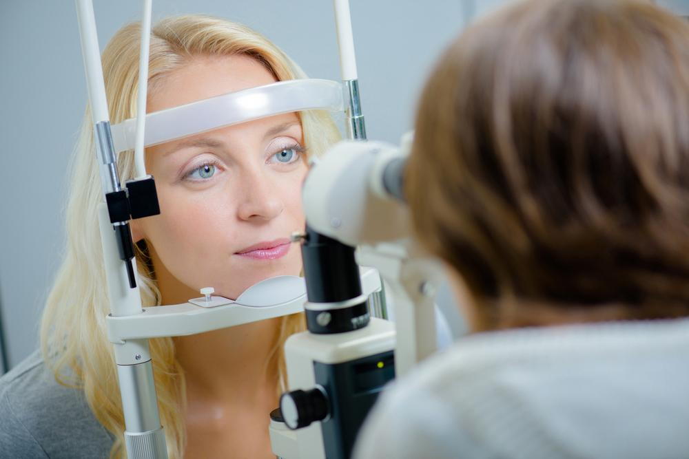 woman getting an eye exam from her optometrist