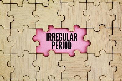 Wooden puzzle with two missing pieces symbolizing irregular menstrual cycle.
