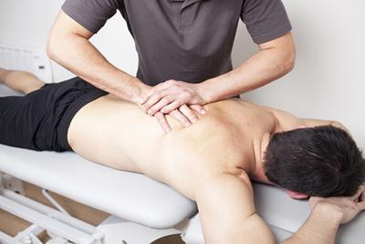 Therapeutic massage by chiropractor for a male patient