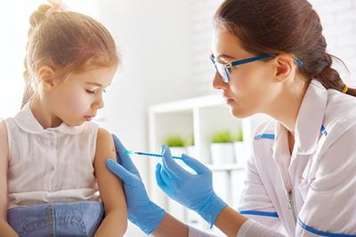 Little girl staying calm while getting vaccinated