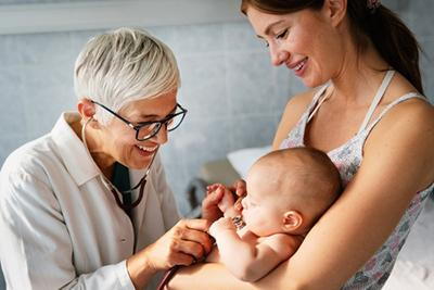 Doctor checking the baby with the mother