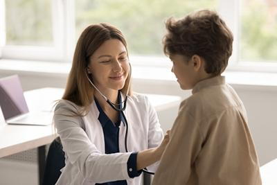 Doctor checking the young boys health