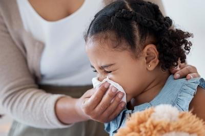 Little girl having a colds wipe by her mother