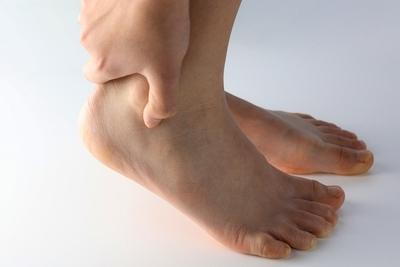 Hand-gripping-heel,-showing-Achilles-discomfort.