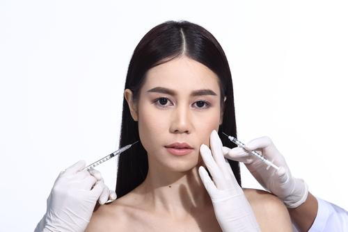 A woman receiving Botox and dermal filler injections for facial rejuvenation.