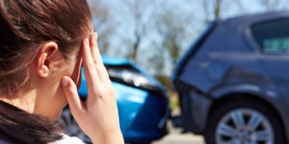 A woman looking at car accident