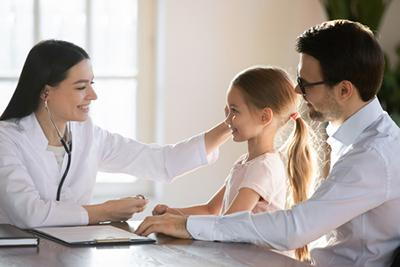 Doctor-touching-the-head-of-little-girl-consultation-with-the-father.