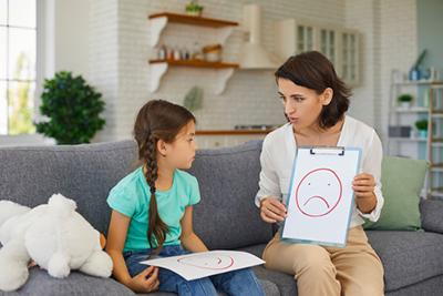 Little girl receiving autism evaluation from pediatrician