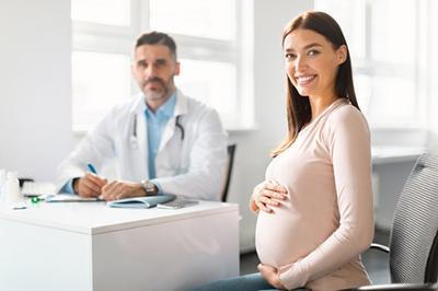 Pregnant woman smiling visit the doctor on clinic