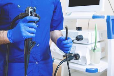 Gastroenterologist demonstrating an endoscope
