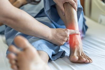 Person with ankle pain highlight in red