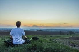 man staring at sunset