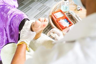 Doctor treating diabectic wound on clinic