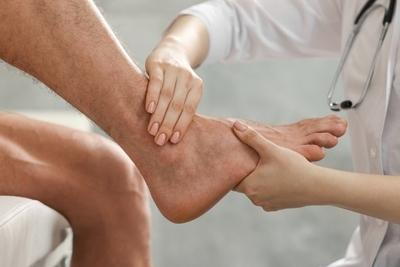 Doctor checking the foot condition of patient